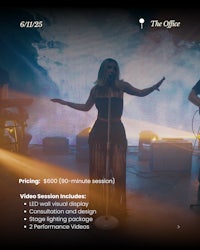 a screen showing a group of people performing on stage