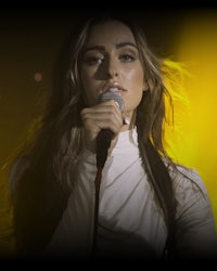 a woman is singing into a microphone