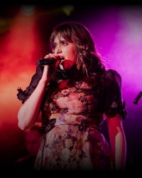 a woman singing into a microphone
