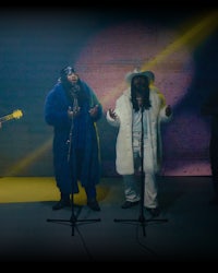 a group of people singing in front of a microphone